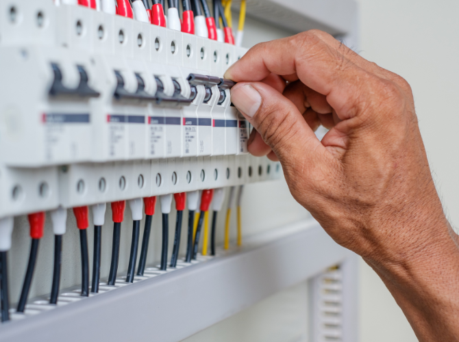 Mão masculina instalando disjuntores