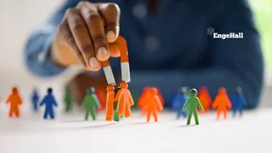 imagem ilustrativa de uma mão segurando um imã que atrai bonequinhos coloridos para representar a atração de talentos